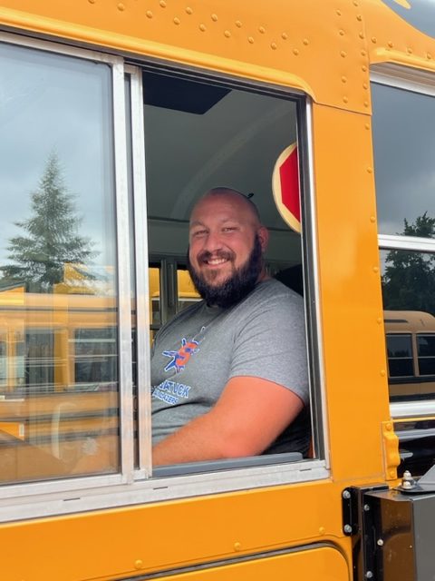 male bus driver sitting in bus